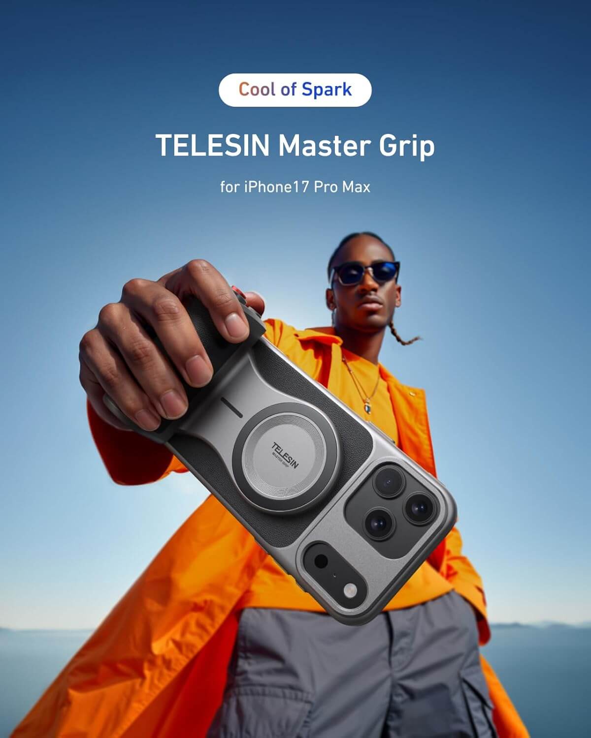 Person holding a TELESIN Master Grip phone case with a blue sky background